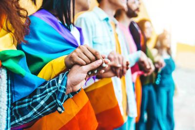 Group of people holding pride banner