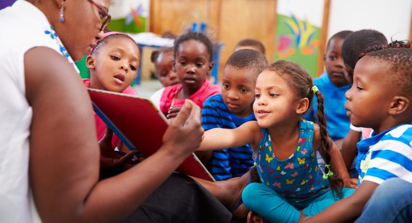 Woman reading to group of children