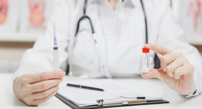 Nurse holding vaccines and paperwork