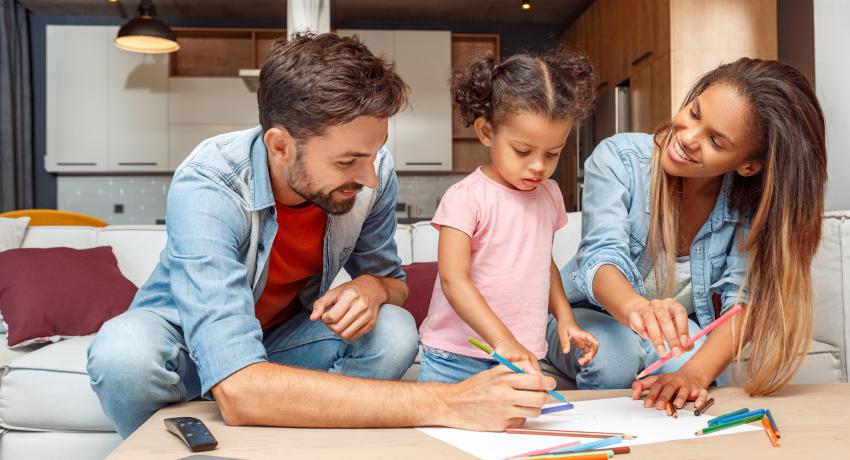 man and woman drawing with young girl