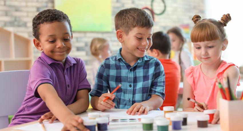 three young kids at desk 